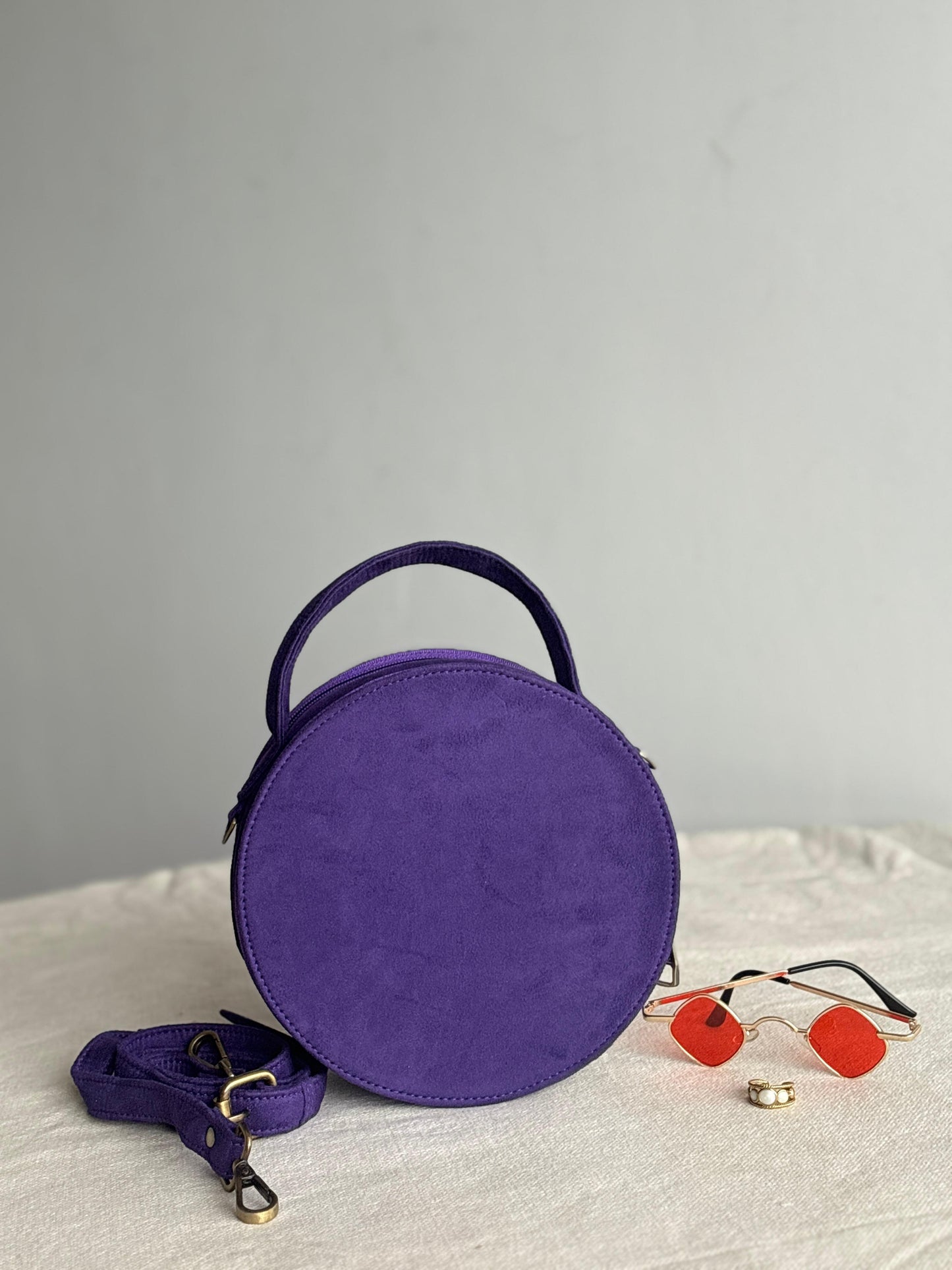 Purple studded round drum bag - front angle view