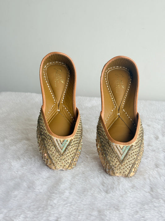 Zehra Gold Juttis with geometric metallic embellishment