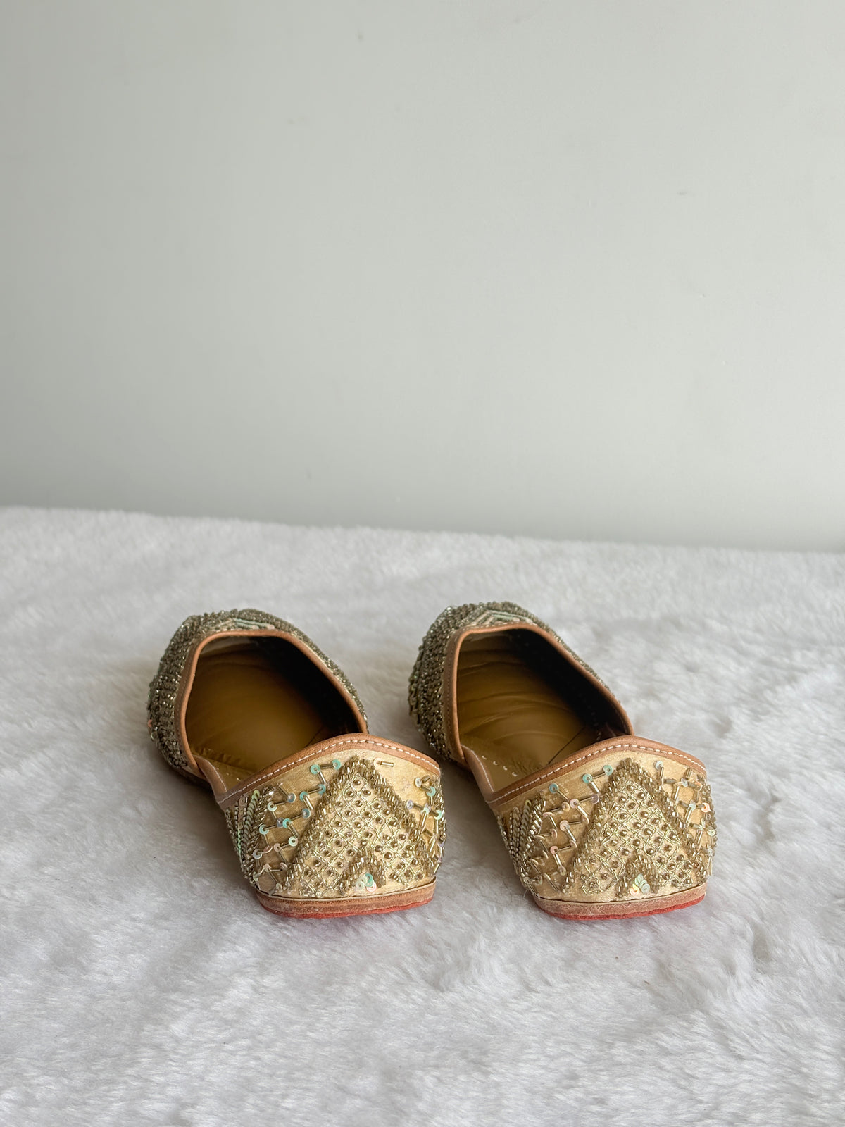 Zehra Gold Juttis heel detailing