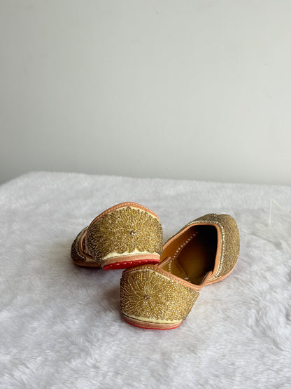 Close view of Aurelia Gold Juttis floral detailing