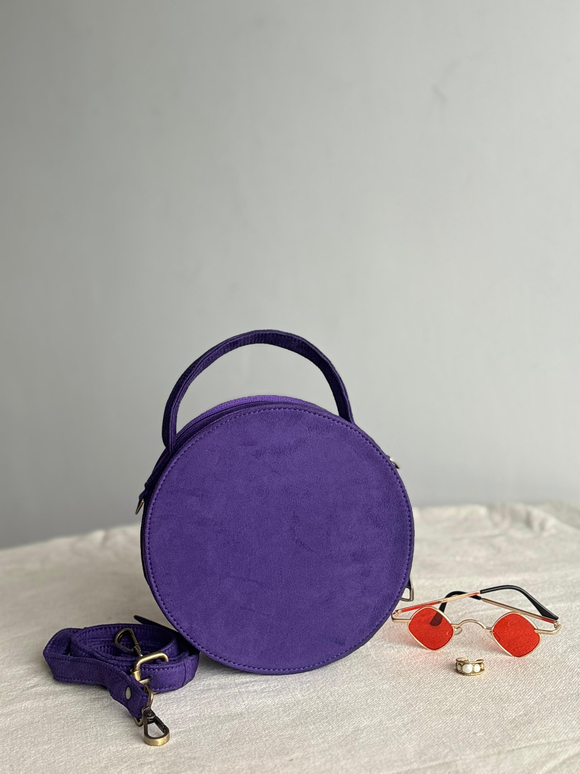 Purple studded round drum bag - front angle view